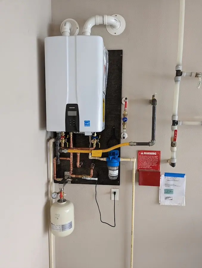 Professional plumber installing copper piping in a Linton Hall home